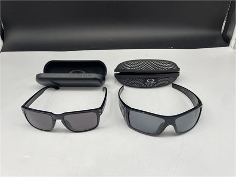 2 PAIRS OF OAKLEY SUN GLASSES W/ CASES (Right pair has minor scratches)
