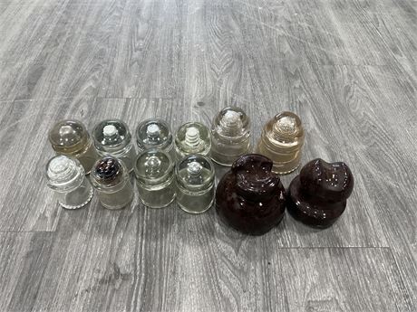 12 VINTAGE GLASS INSULATORS - MOSTLY 4” TALL - SOME HAVE SMALL CHIPS