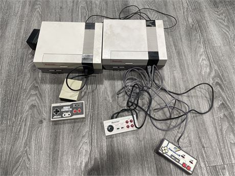 2 NES CONSOLES WITH 3 CONTROLLERS INCLUDING WIRELESS (POWERS ON)