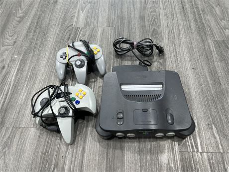 N64 CONSOLE W/ 2 CORDS (1 IS ORIGINAL BUT STICK IS LOOSE)