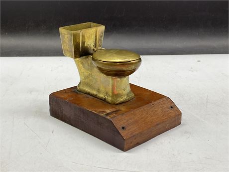OLD BRASS TOILET ASHTRAY ON WOODEN BASE (5” TALL)