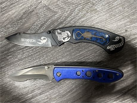 2 NEW FOLDING KNIVES (8”) 1 HAS REAL SCORPION IN HANDLE