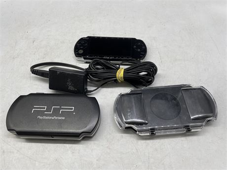 PSP WITH CHARGER, CASE & GAMES CASE
