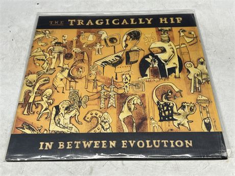 THE TRAGICALLY HIP - IN BETWEEN EVOLUTION - MINT (M)