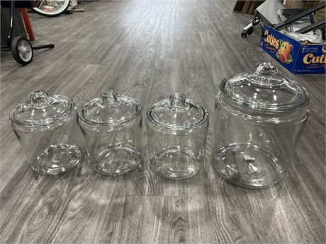 4 LIDDED GLASS CANDY JARS - LARGEST IS 11” TALL 8” DIAM