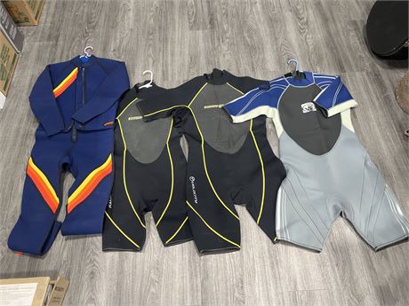 4 WET SUITS - ASSORTED SIZES - MOSTLY LARGE / XL