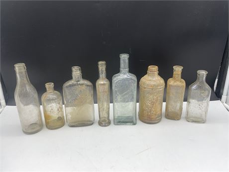 8 ASSORTED SIZE CLEAR BOTTLES 5”-9” EXCAVATED FROM 237 E.PENDER