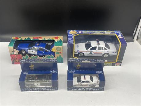 4 RCMP CARS: ALL MIB (UNOPENED) - 1 IS A COIN BANK