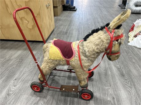 1950’S AND STUFFED RIDE ON DONKEY ON WHEELS