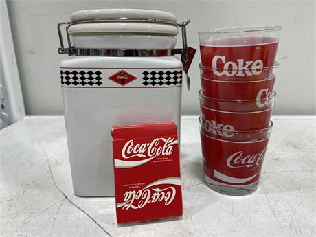 COCA COLA CANISTER, 4 GLASSES, AND PLAYING CARDS