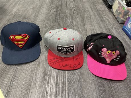 PINK SNAPBACK CAP, TEAM SIGNED SRAM CAP, & SUPERMAN CAP