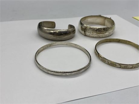 4 SILVER BANGLES - ONE MARKED STERLING, OTHERS UNMARKED / UNKNOWN
