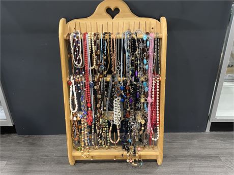 LARGE COLLECTION OF VINTAGE NECKLACES ON WOOD THREAD HOLDER (19.5”X34”)