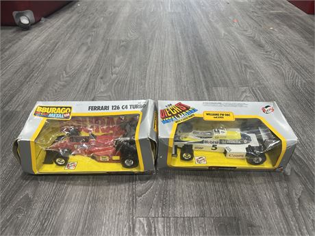 (2) 1/24 SCALE BURAGO F1 DIE CAST CARS - BOXES HAVE DAMAGE