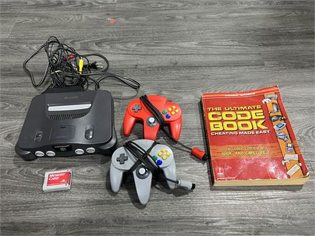 N64 CONSOLE W/CONTROLLERS, MEMORY CARD & CHEAT BOOK
