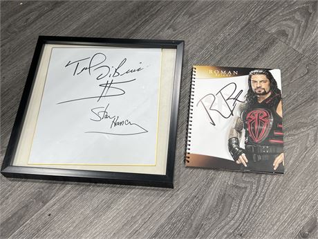 ROMAN REIGNS SIGNED BOOK & STAN HANSEN / TED DIBRASE SIGNED PIECE (13”x13”)