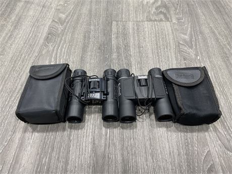 2 BUSHNELL 10x25 BINOCULARS 302FT / 1000 YARDS WITH CASES