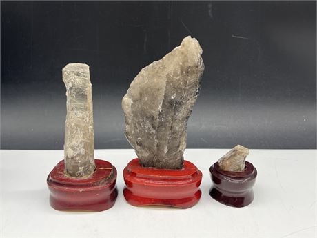 3 SMOKEY QUARTZ ON WOOD STANDS - LARGEST IS 5”