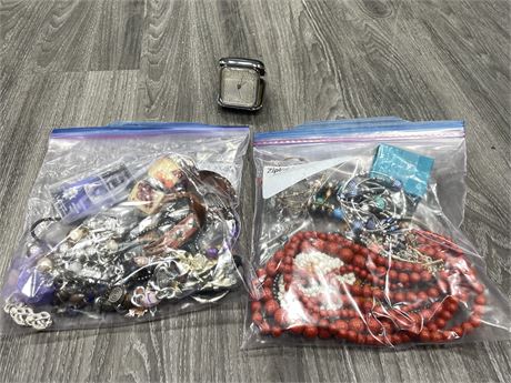 2 BAGS OF ASSORTED COSTUME JEWELRY & TRAVEL CLOCK