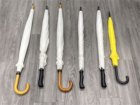 5 WHITE UMBRELLAS AND 1 YELLOW ONE (LARGEST IS 41” LONG, SMALLEST IS 34”)