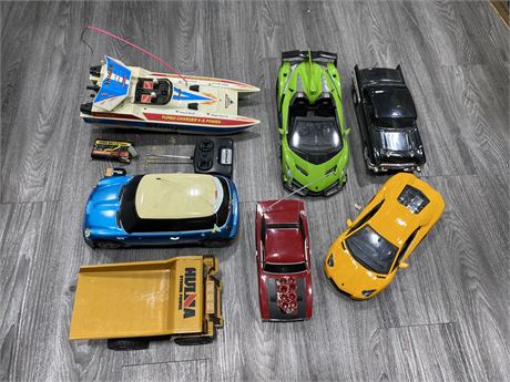 LOT OF RC CARS & RC BOAT (Has remote & battery, unaware if working)