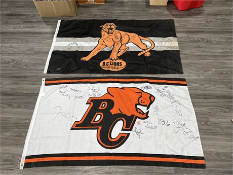 2 BC LIONS TEAM SIGNED FLAGS - 34”x61”