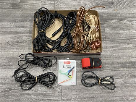 BOX OF GUITAR ITEMS - NEW CAPO, STRAP, + 1/4 CABLES