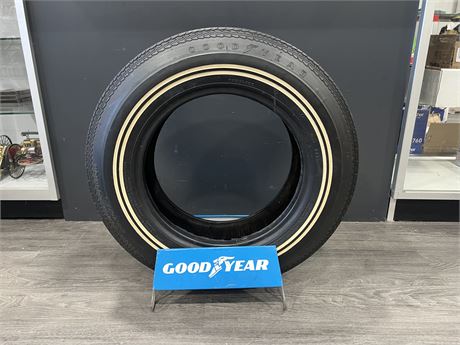 VINTAGE GOOD YEAR BIAS PLY TIRE (NEVER USED) ON FACTORY STAND